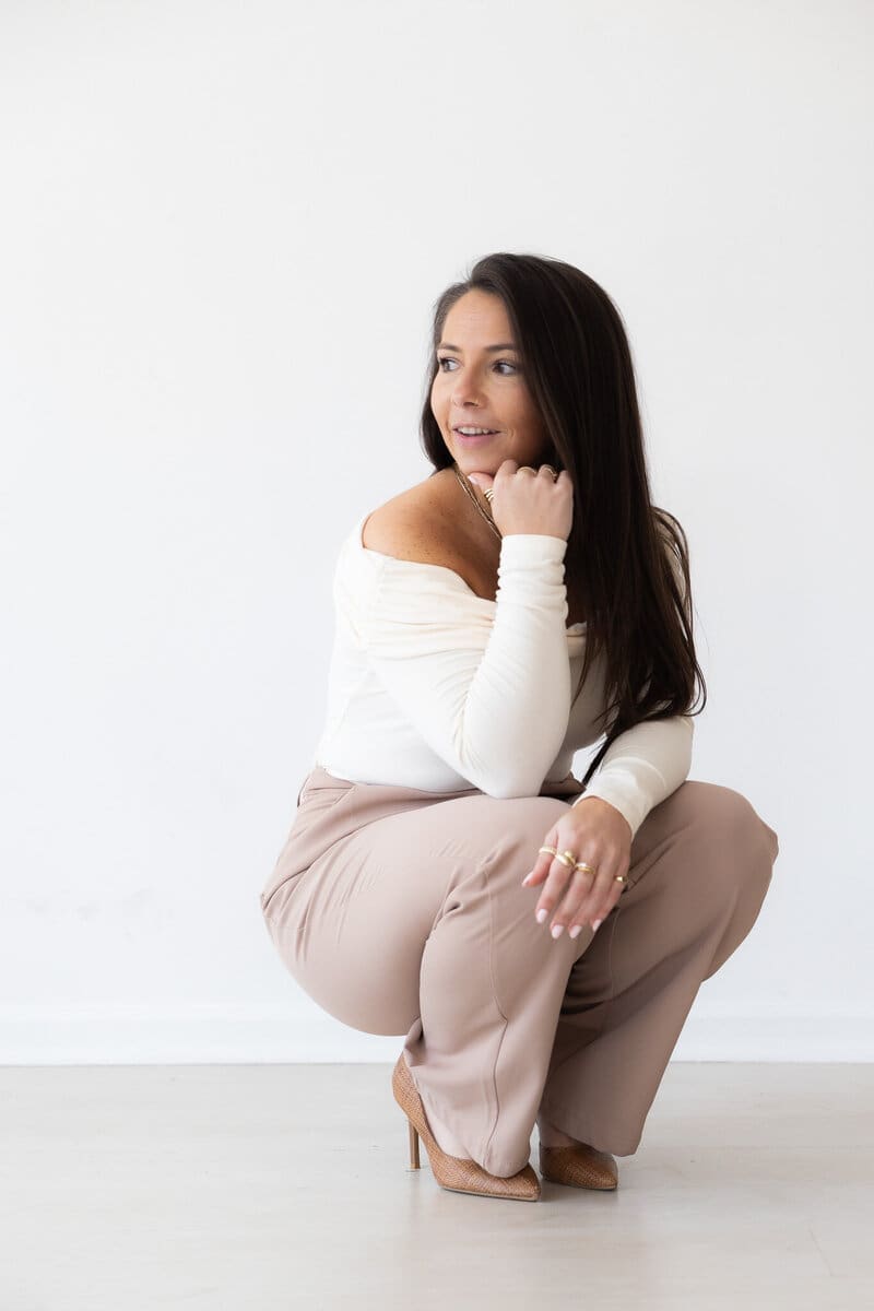Branding photo of model in front of white backdrop for real estate photography