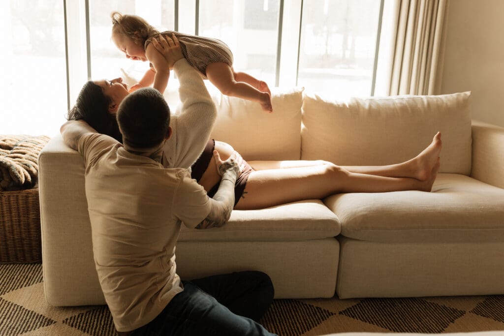 Pregnant mother and father cuddling their toddler during a lifestyle maternity photoshoot in New Jersey