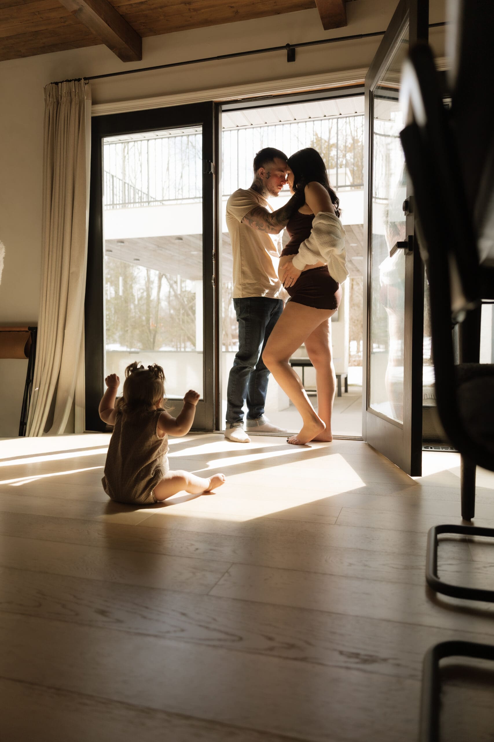 Pregnant mother cuddling her toddler during a lifestyle maternity photoshoot in New Jersey